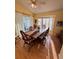 Sunlit dining room with wood table, chairs, and bay window at 25527 Oak Aly, Leesburg, FL 34748