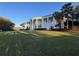 Stately building featuring soaring columns, lush landscaping, and a walkway to the front entrance at 25527 Oak Aly, Leesburg, FL 34748
