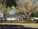 View of back of home and common community areas, manicured hedge at 25527 Oak Aly, Leesburg, FL 34748