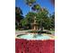 Beautiful fountain surrounded by bright red flowers and lush greenery at 25527 Oak Aly, Leesburg, FL 34748