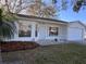 A front exterior shot with an attached garage and mature palm tree at 25527 Oak Aly, Leesburg, FL 34748