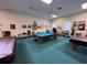 Game room featuring pool tables, chairs, and charming decor for leisure activities at 25527 Oak Aly, Leesburg, FL 34748
