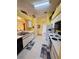 Well-lit kitchen with white appliances and cabinets, tiled floor and a view to the living room at 25527 Oak Aly, Leesburg, FL 34748