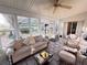Sun-drenched lanai featuring comfortable seating and views of the backyard at 25527 Oak Aly, Leesburg, FL 34748