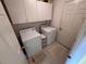 Efficient laundry room with washer, dryer, cabinets and tile flooring at 25527 Oak Aly, Leesburg, FL 34748