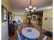 Open-concept living room with dining area, laminate floors, and lots of natural light at 25527 Oak Aly, Leesburg, FL 34748