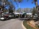 Exterior of restaurant with golf carts parked in front; landscape and manicured lawn add to the curb appeal at 25527 Oak Aly, Leesburg, FL 34748