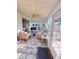 Bright sunroom with tile flooring, ceiling fan, and sliding door to outdoor patio at 25527 Oak Aly, Leesburg, FL 34748