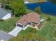 Aerial view of the home featuring a picturesque lake, beautiful landscaping, and a private setting at 26636 Evert St, Leesburg, FL 34748