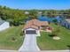 Beautiful home featuring a lake view, well-manicured lawn, and mature trees at 26636 Evert St, Leesburg, FL 34748