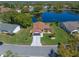 Beautiful aerial view of home overlooking the lake and lush landscaping in a friendly neighborhood at 26636 Evert St, Leesburg, FL 34748