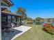 Enjoy outdoor living on this patio with tranquil water views and lush landscaping at 26636 Evert St, Leesburg, FL 34748