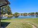 Relaxing backyard featuring a serene water view and lush green lawn at 26636 Evert St, Leesburg, FL 34748