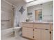 Bathroom featuring a tub with shower and a vanity with mirror, offering a functional layout at 26636 Evert St, Leesburg, FL 34748