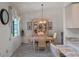 Charming dining room with a decorative chandelier and neutral color palette at 26636 Evert St, Leesburg, FL 34748