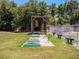 Driving range with covered hitting area, clear views of the fairway, and mature trees at 26636 Evert St, Leesburg, FL 34748