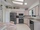 Bright kitchen with stainless steel appliances, skylight, and ample counter space at 26636 Evert St, Leesburg, FL 34748