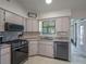 Efficient kitchen with stainless steel appliances and generous counter space at 26636 Evert St, Leesburg, FL 34748