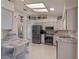 Well-lit kitchen with stainless steel appliances and tile flooring at 26636 Evert St, Leesburg, FL 34748