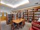 Cozy library with floor-to-ceiling bookshelves, a large table, and comfortable seating at 26636 Evert St, Leesburg, FL 34748