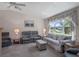 Spacious living room offering comfortable seating, neutral carpet, and bright natural light at 26636 Evert St, Leesburg, FL 34748