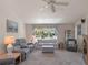 Bright living room with a large window, neutral carpet, and comfortable seating at 26636 Evert St, Leesburg, FL 34748