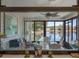Sunroom with panoramic lake views, ceiling fan and seating area at 26636 Evert St, Leesburg, FL 34748