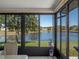 Beautiful sunroom boasting large windows providing great view of tranquil lake at 26636 Evert St, Leesburg, FL 34748