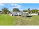 View of the home's backyard featuring a storage shed, and partial fencing at 27 Florence Blvd, Debary, FL 32713
