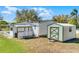 Backyard view featuring a white home exterior, and a storage shed at 27 Florence Blvd, Debary, FL 32713