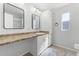 Bathroom featuring a long countertop and vanity, matching cabinets, mirror, and a neutral color palette at 27 Florence Blvd, Debary, FL 32713