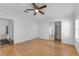 Bright bedroom featuring hardwood floors, a ceiling fan, closet, and light-colored walls at 27 Florence Blvd, Debary, FL 32713