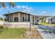 Charming single-story home featuring a carport, screened-in porch, and well-maintained landscaping at 27 Florence Blvd, Debary, FL 32713