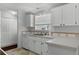 Kitchen features white cabinets and tile backsplash at 27 Florence Blvd, Debary, FL 32713