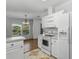 Bright kitchen with stove and white cabinets, and dining area at 27 Florence Blvd, Debary, FL 32713