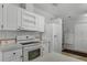 The bright kitchen is equipped with a modern oven and ample white cabinets at 27 Florence Blvd, Debary, FL 32713