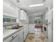 Bright kitchen with white cabinets, stainless steel appliances, and a sunny breakfast nook at 27 Florence Blvd, Debary, FL 32713