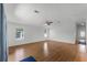 Bright living room with wood flooring, neutral walls, and a ceiling fan at 27 Florence Blvd, Debary, FL 32713
