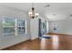 Bright living room with wood flooring, neutral walls, and ample natural light from windows and a sliding door at 27 Florence Blvd, Debary, FL 32713