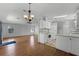 Bright living room with wood flooring, neutral walls, and ample natural light from windows and a sliding door at 27 Florence Blvd, Debary, FL 32713