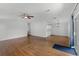 Bright living room with wood flooring, neutral walls, and view of dining area and kitchen at 27 Florence Blvd, Debary, FL 32713