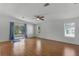 Bright living room with wood flooring, neutral walls, and a ceiling fan at 27 Florence Blvd, Debary, FL 32713