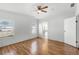 Bright and spacious main bedroom with wood floors and ceiling fan at 27 Florence Blvd, Debary, FL 32713