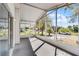 Covered porch with a screen and view of the street and surrounding greenery at 27 Florence Blvd, Debary, FL 32713