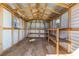 Interior of the storage shed featuring shelving, wood flooring, and plenty of natural light at 27 Florence Blvd, Debary, FL 32713