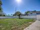 Large, fenced backyard with green grass and partial wood deck at 2741 S Brown Ave, Orlando, FL 32806