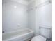 Bathroom featuring a tiled bathtub, white fixtures, and neutral walls at 2741 S Brown Ave, Orlando, FL 32806