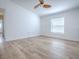 Bright bedroom with wood-look flooring, a ceiling fan, and a large window at 2741 S Brown Ave, Orlando, FL 32806