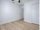 This is a bright bedroom featuring neutral paint and wood-look laminate flooring and a closet at 2741 S Brown Ave, Orlando, FL 32806