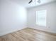 A light-filled bedroom with neutral paint, light wood laminate flooring, and a window at 2741 S Brown Ave, Orlando, FL 32806